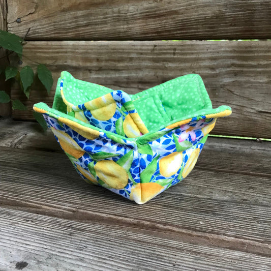 Colorful fabric item with lemon pattern against a wooden background